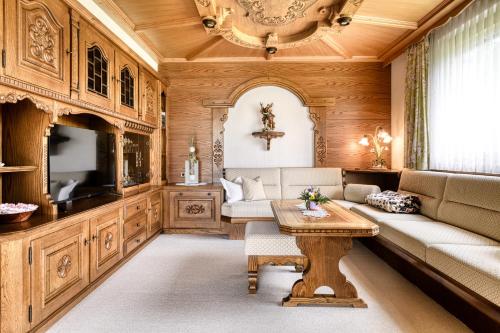 a living room with a couch and a table at Landhaus Bergblick in Ludesch
