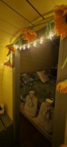 a room with a bunk bed with lights and towels at Ty Grug Retreat in Little Newcastle
