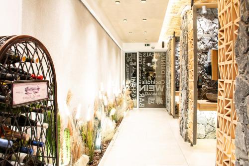 a wine tasting room with wine bottles on the wall at Yianna Caravel Suites "by Checkin" adults only in Amoudara Herakliou