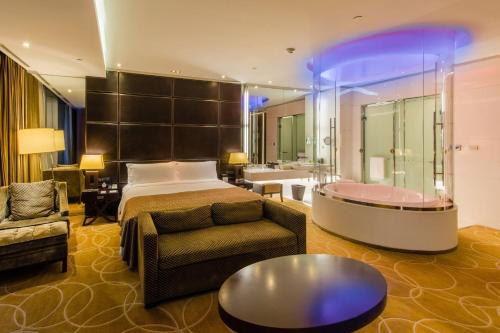 a hotel room with a bed and a bath tub at InterContinental Nanjing by IHG in Nanjing