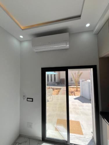 a room with a sliding glass door with a patio at DjerbaArkouMidoun in Arkou