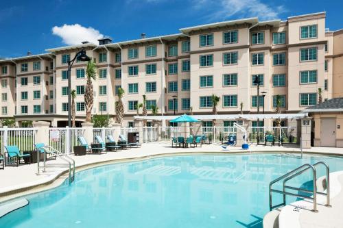 a large pool in front of a hotel at Residence Inn by Marriott Near Universal Orlando in Orlando