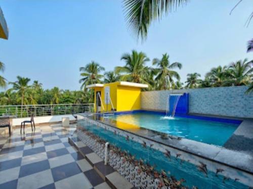 a pool with a water slide in a resort at Villa platinum 4 BHK Calangute in Calangute