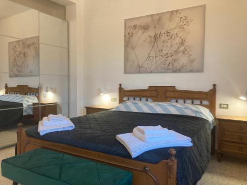 a bedroom with a bed with towels on it at Casa Nostra in Martinsicuro