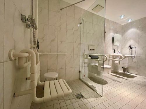 a bathroom with a shower and a sink at Aspire AcarA Oldenburg, Trademark Collection by Wyndham in Oldenburg
