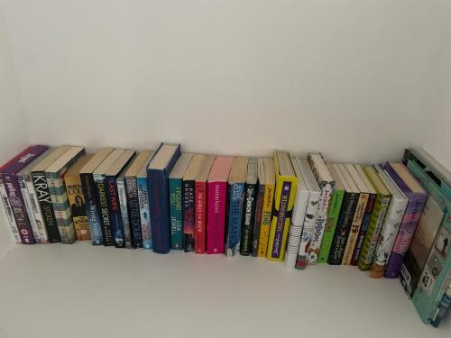 eine Reihe von Büchern auf einem Regal in der Unterkunft 2 bedroom country cottage in the Lake District in Penrith