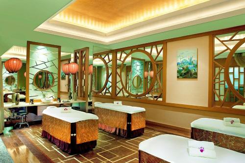 a waiting room with two tables and mirrors at Sheraton Ningbo Hotel - Tianyi Square in Ningbo