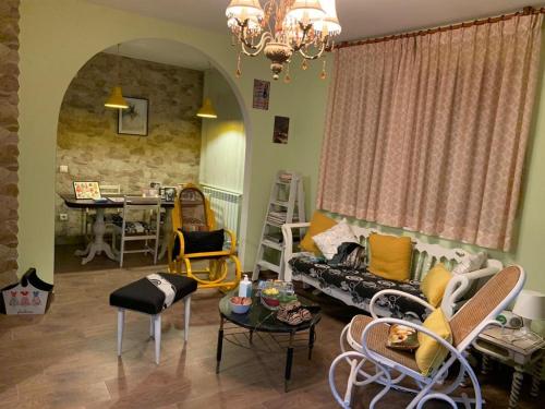 a living room with a couch and chairs and a table at Casa Rural Abuela Carolina in Bermillo de Sayago