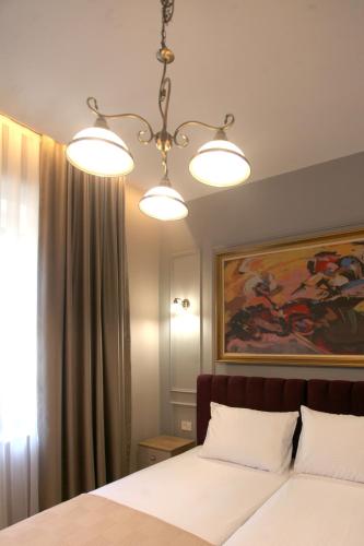 Łóżko lub łóżka w pokoju w obiekcie Portal Villa Apartments