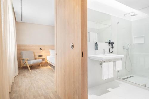 a bathroom with a shower and a sink and a toilet at Moov Apartments Boavista in Porto