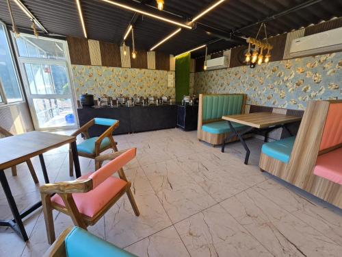 a restaurant with tables and chairs in a room at Nature on the Rocks Glamping Resort in Shivpuri