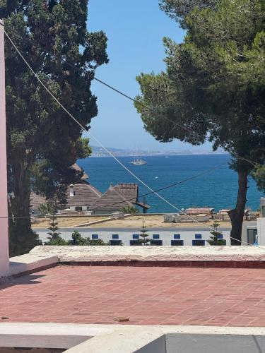 a view of the ocean from a building at Maison Residence mdiq marsa in M'diq