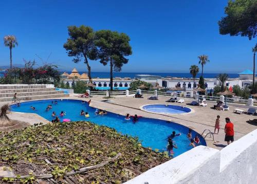 a group of people in a swimming pool at Maison Residence mdiq marsa in M'diq