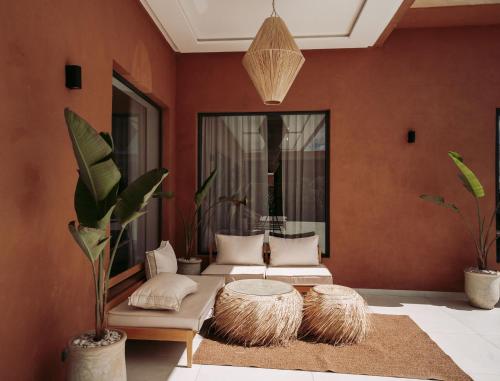 a living room with two couches and a table at Domaine de Kali, villa 2 au calme, piscine privée in Marrakech
