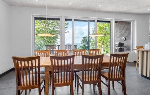 a dining room with a wooden table and chairs at Awesome Home In Spøttrup With Wifi in Lihme