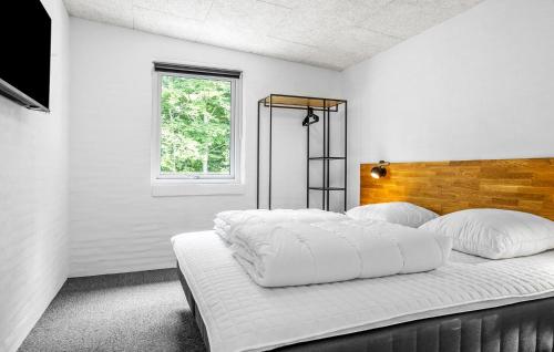 a white bedroom with a large bed with white pillows at Awesome Home In Spøttrup With Wifi in Lihme