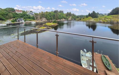 a view of a river with two chairs on a dock at Amazing Home In Bremnes With Wifi in Bremnes