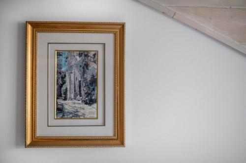 a framed picture of a forest on a wall at Bakony Resort - a Felnőttbarát Hotel - Szarvaskút Vendégpark in Zirc