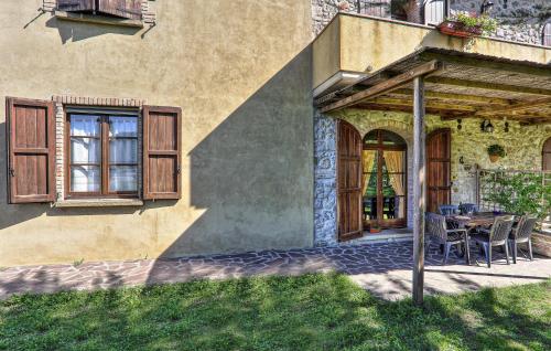 a house with a table and chairs in front of it at Amazing Home In Pomarance in Pomarance