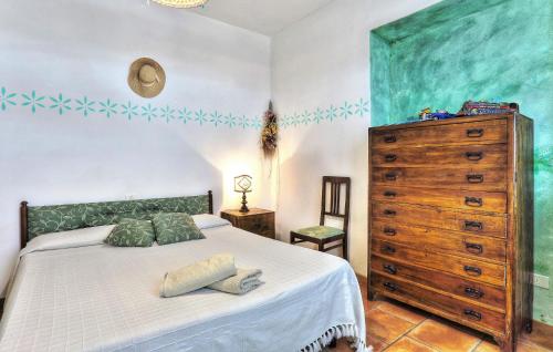 a bedroom with a large bed and a dresser at Amazing Home In Pomarance in Pomarance