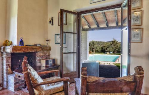 a living room with a fireplace and a door to a pool at Amazing Home In Pomarance in Pomarance