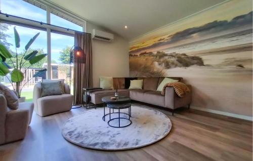 a living room with a couch and a table at Beautiful Home In Voorthuizen in Voorthuizen