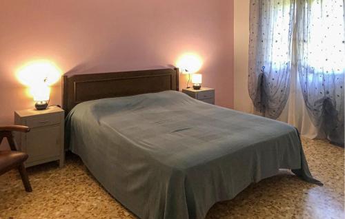 a bedroom with a bed with two night stands and two lamps at Nice Home In Sestino With House A Panoramic View in Sestino