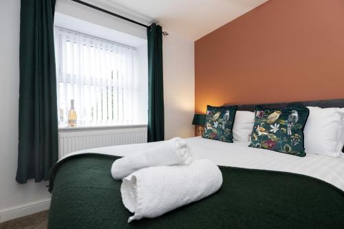 a bedroom with a bed with a towel on it at Bob Hannah Cottage in Cockfield