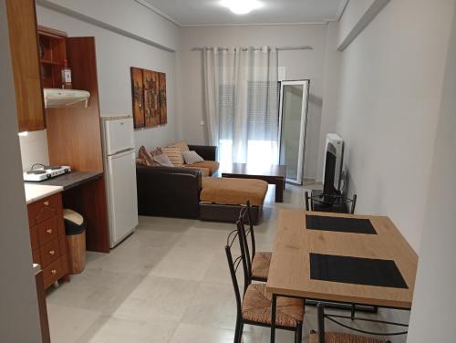 a kitchen and a living room with a table at Central apartment's in Trikala 2 in Tríkala