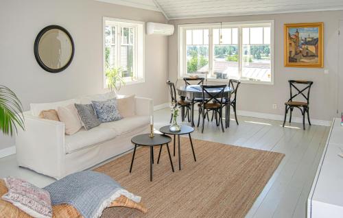 a living room with a white couch and a table at 1 Bedroom Gorgeous Home In Stallarholmen in Stallarholmen