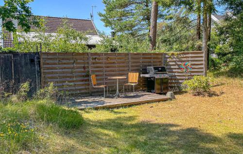 a backyard with a table and chairs and a fence at 3 Bedroom Gorgeous Home In Mellbystrand in Mellbystrand