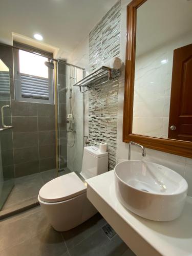 a bathroom with a sink and a toilet and a shower at Paralian Hulhumale' in Hulhumale