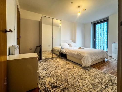 a bedroom with a bed and a large mirror at Flat in Greater manchester in Manchester