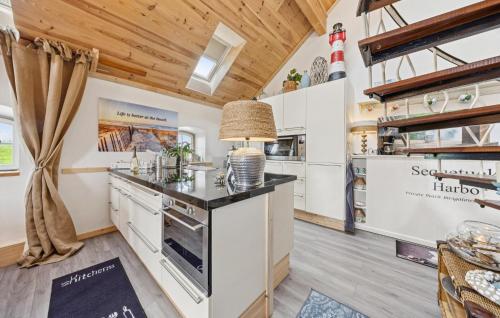 a kitchen with white cabinets and a counter top at Beach House in Detern
