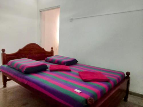 a bed with two pillows on it in a room at Kelaniya Guest House in Peliyagoda