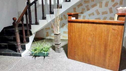 a staircase with a wooden railing and some plants at Kelaniya Guest House in Peliyagoda