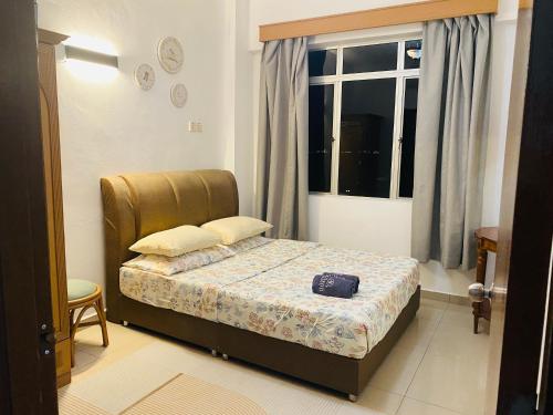 a small bedroom with a bed and a window at FA Seaview Glory Beach Resort in Port Dickson