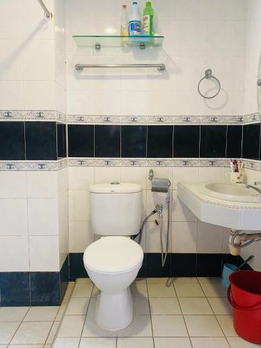 a bathroom with a toilet and a sink at FA Seaview Glory Beach Resort in Port Dickson