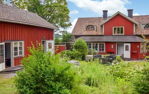 a red house next to a red house at 2 Bedroom Lovely Home In Sättersta Tystberga 