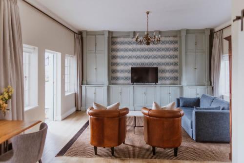 a living room with two chairs and a couch at Laborie Estate in Paarl
