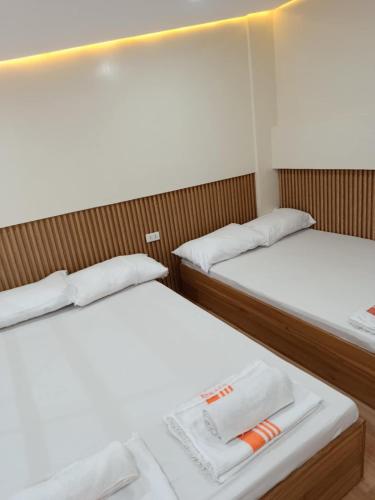 a pair of beds in a small room at The Tree House - Connecting Loft Units Govantes in Vigan