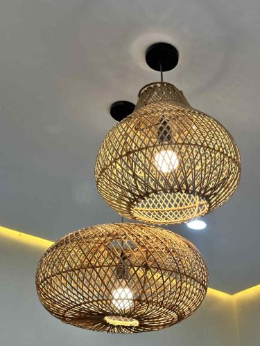 two lights are hanging from a ceiling at The Tree House - Connecting Loft Units Govantes in Vigan
