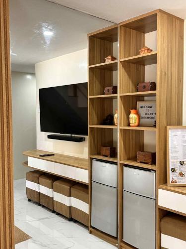 a living room with a entertainment center with a flat screen tv at The Tree House - Connecting Loft Units Govantes in Vigan