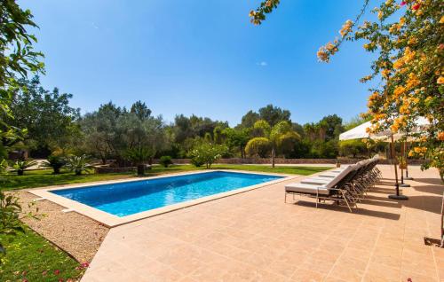 a swimming pool in a yard with a bench at Can Sanchez in Campos