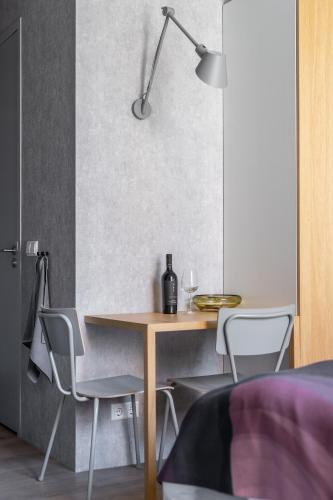 a dining room with a table and chairs and a lamp at 348 Suites Short Stay in The Hague