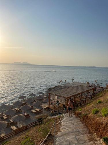 a person walking on a dock in the water at Blue Bay Residence in Vlorë