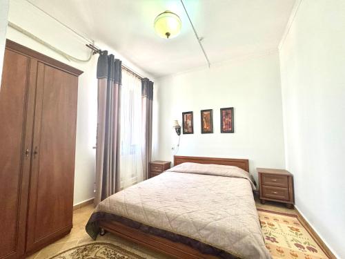 a bedroom with a bed and a large window at Hotel VANGOGH in Zhezdi
