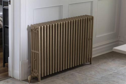 a radiator sitting on a wall in a room at Royale 1918, 6bdr, game room, net, pool & more in Beaupré