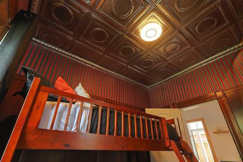a staircase in a room with a coffered ceiling at Royale 1918, 6bdr, game room, net, pool & more in Beaupré