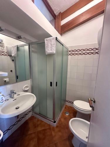 a bathroom with a sink and a toilet at Casa Oliva Ansedonia in Ansedónia